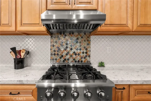 a kitchen with a stove and cabinets