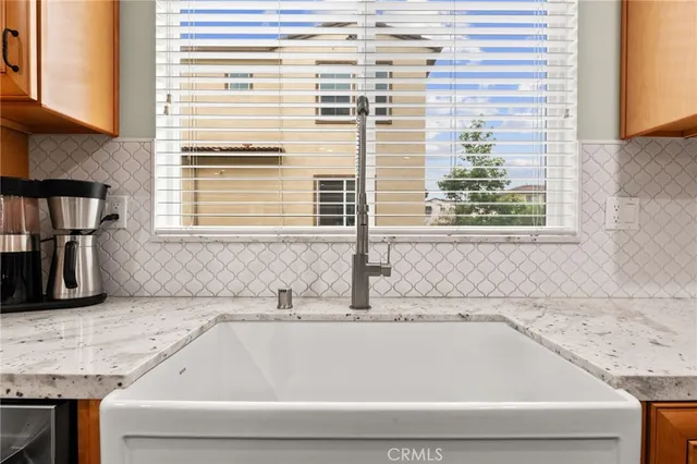 a bathroom with a granite countertop sink and a bathtub