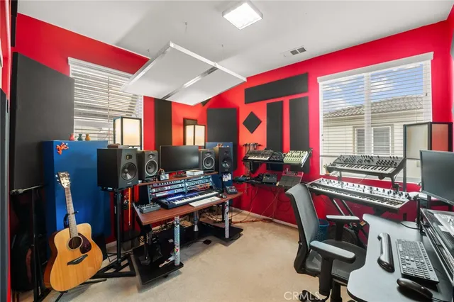 a room with furniture and musical instruments