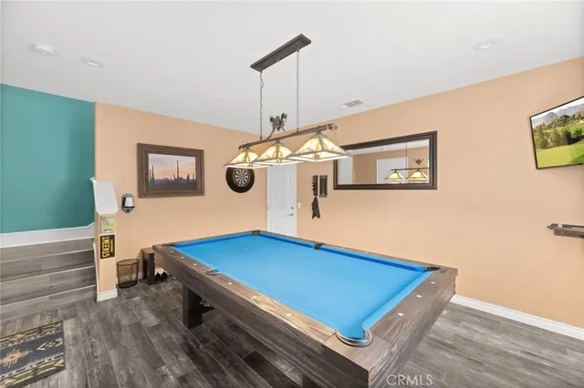 a room with pool table and windows