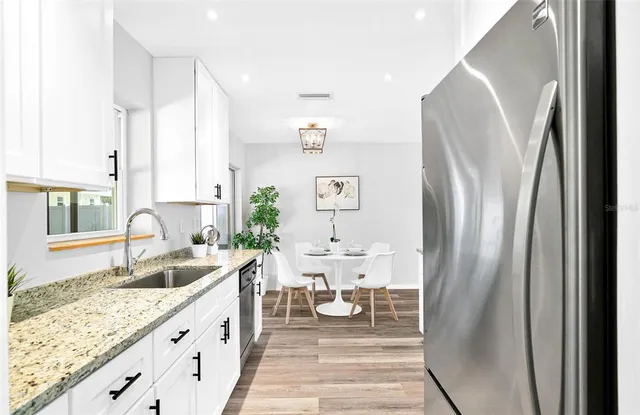 a spacious bathroom with double vanity and a bathtub