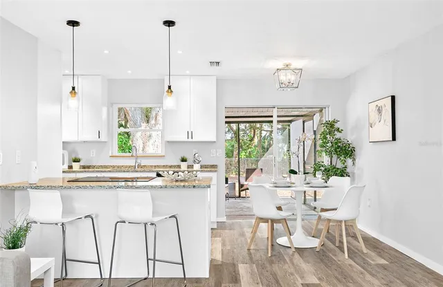 a kitchen with stainless steel appliances kitchen island a large window and cabinets