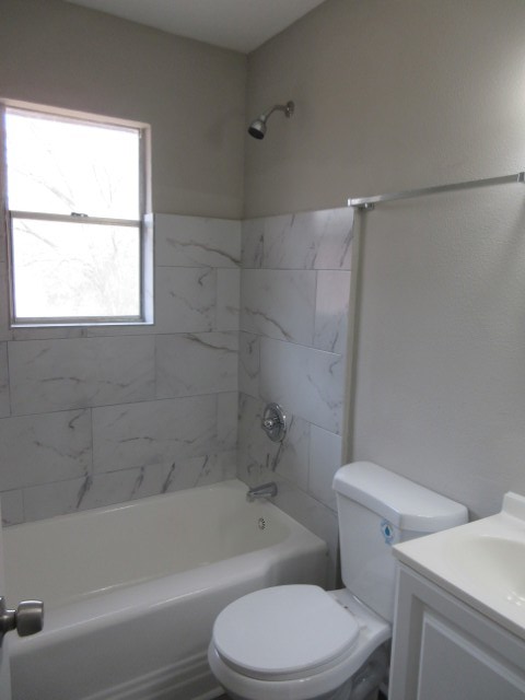 784 Terminal Court, Unit 10 Columbus, GA 31906 - Photo 16 of 26 a white toilet and tub next to a window