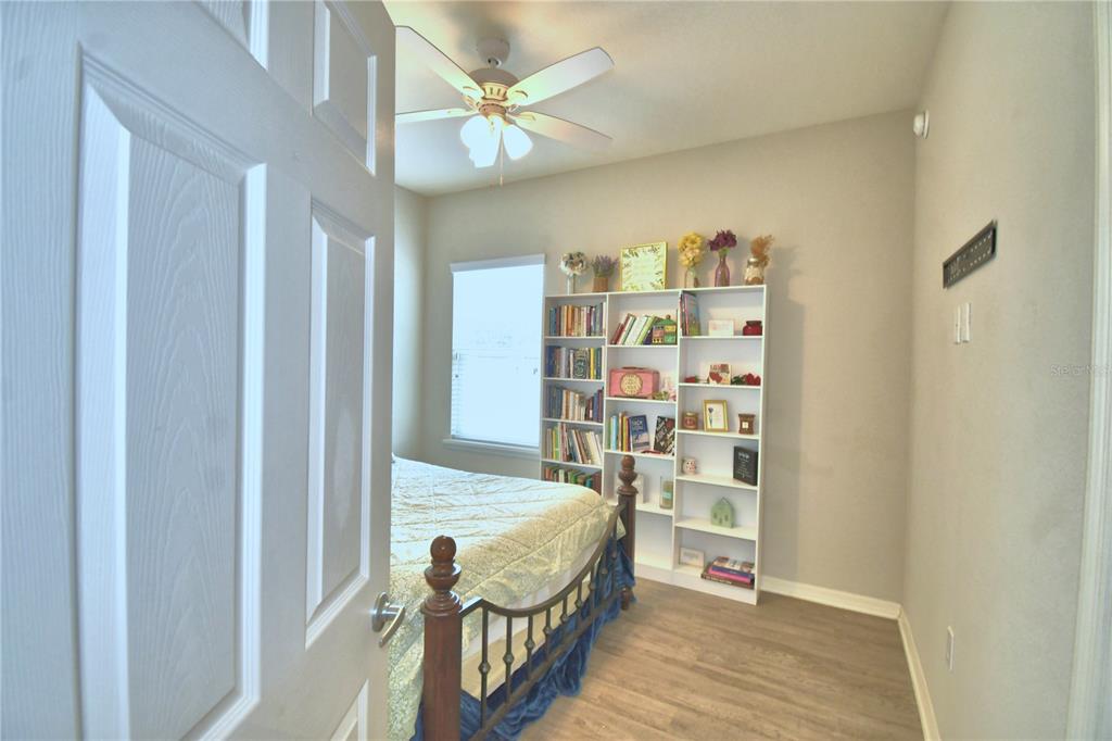4340 Reding Way Lakeland, FL 33813 - Photo 26 of 63 a bedroom with a bed and a book shelf