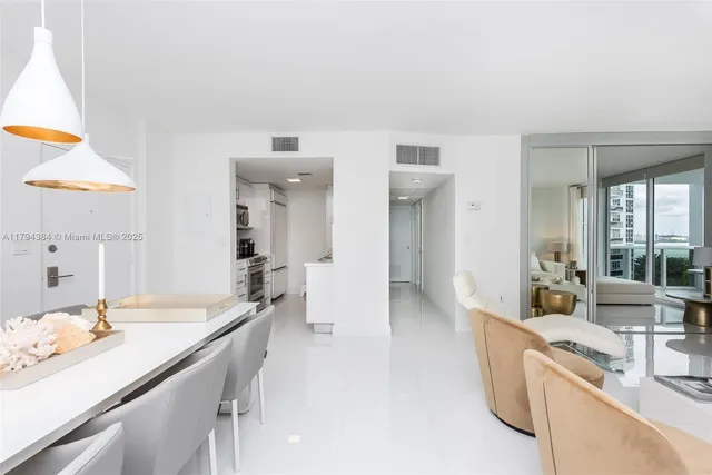 a large white room with a large window and furniture