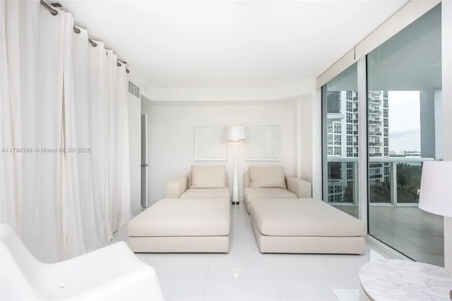 a living room with furniture a large window and a shower