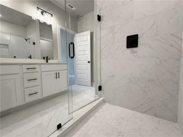 a bathroom with a shower and a sink