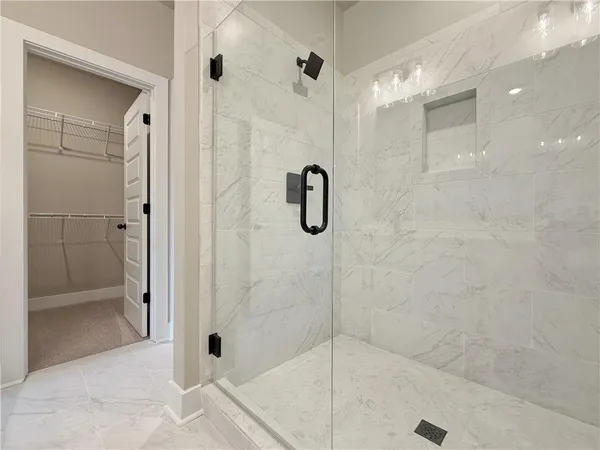 a bathroom with a glass shower door