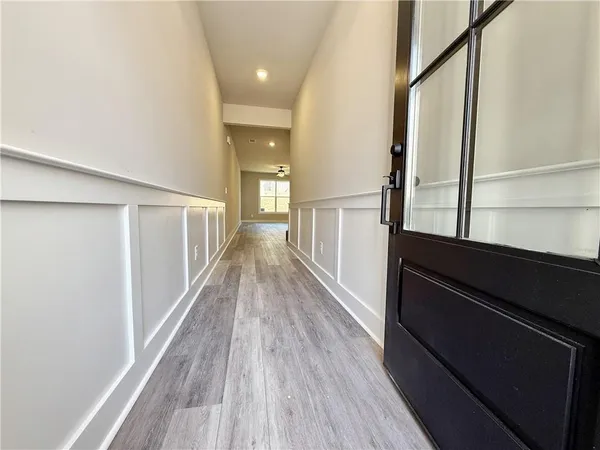 a view of hallway with wooden floor