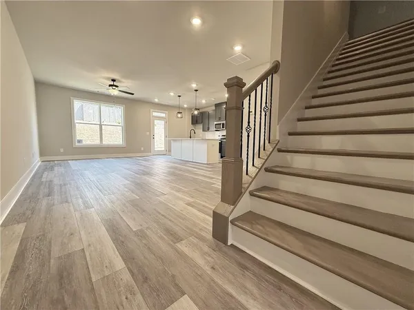 a view of entryway and hall with wooden floor
