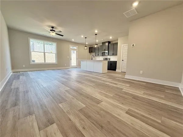 a view of a kitchen with a sink and dishwasher kitchen view with wooden floor