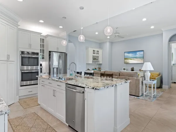 a kitchen with a sink counter top space appliances and cabinets