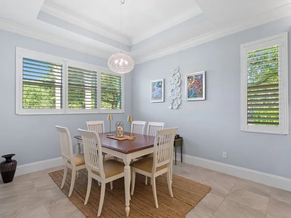 a view of a dining room with furniture and a window