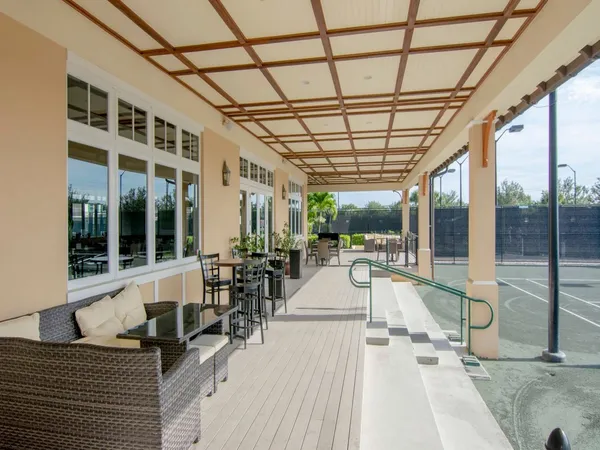 a view of a living room and balcony with furniture