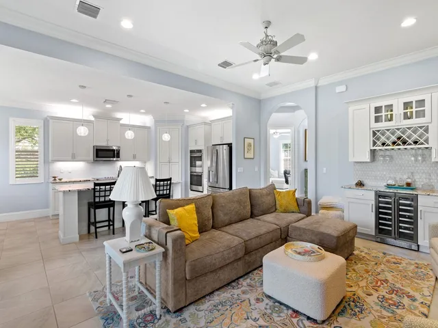 a living room with furniture and a chandelier