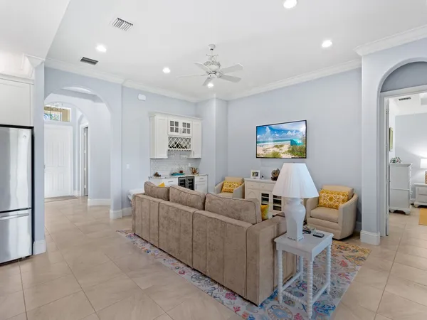 a living room with furniture and a chandelier