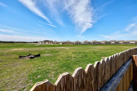 a view of a green yard with a lake view