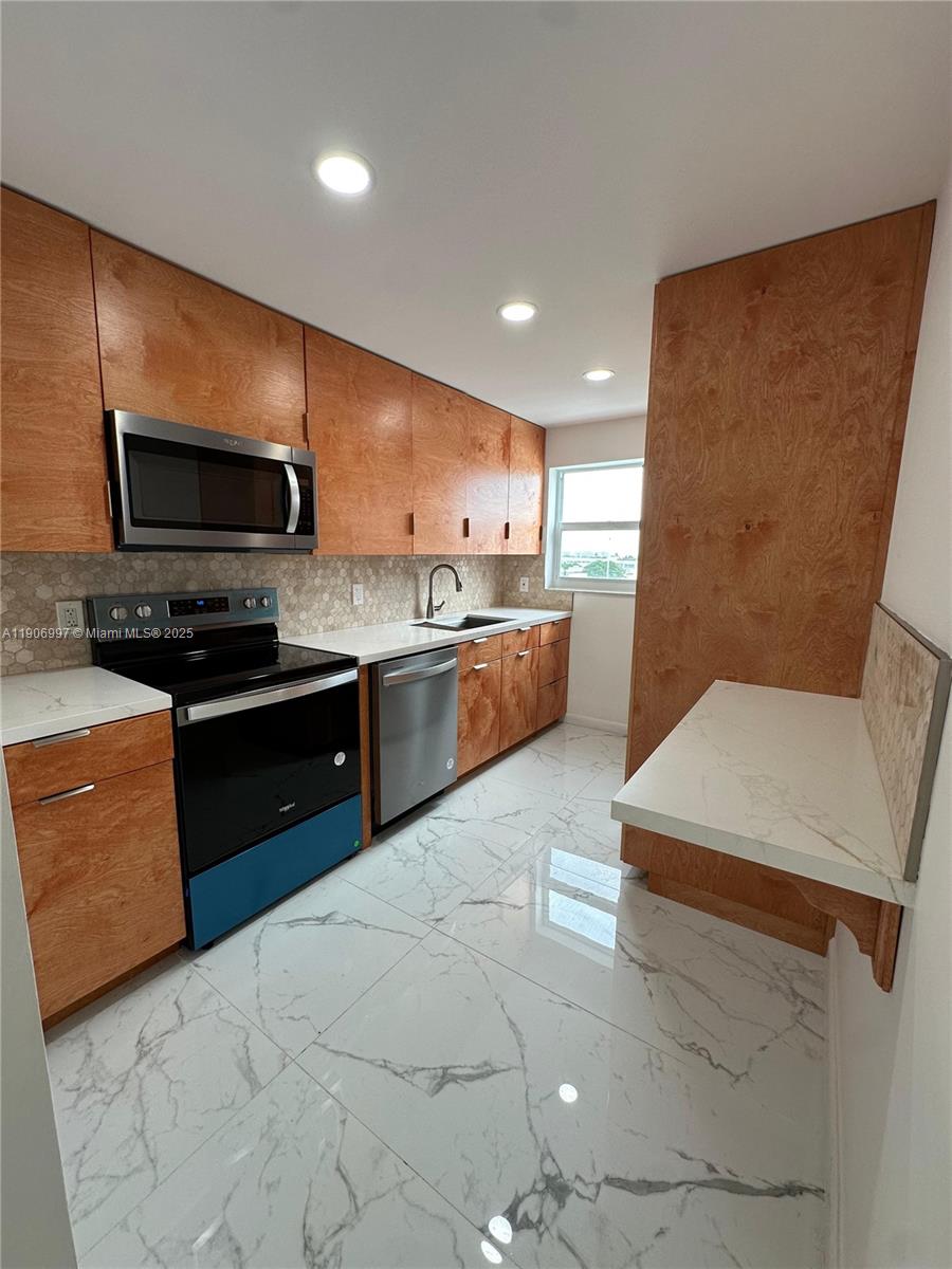 245 18th Street, Unit 801 Miami Beach, FL 33139 - Photo 1 of 11 a kitchen with stainless steel appliances granite countertop a stove a sink and a microwave