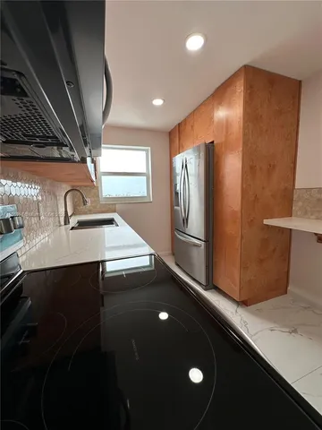 a view of a refrigerator in a kitchen