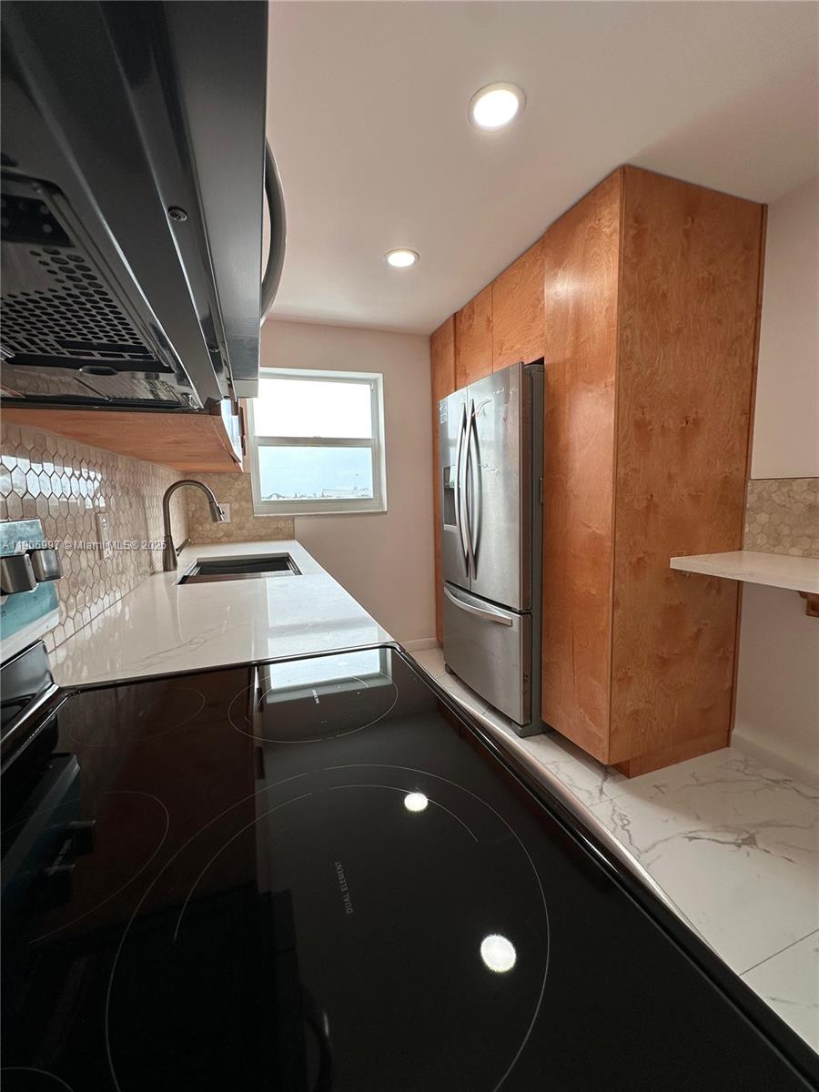 245 18th Street, Unit 801 Miami Beach, FL 33139 - Photo 2 of 11 a view of a refrigerator in a kitchen