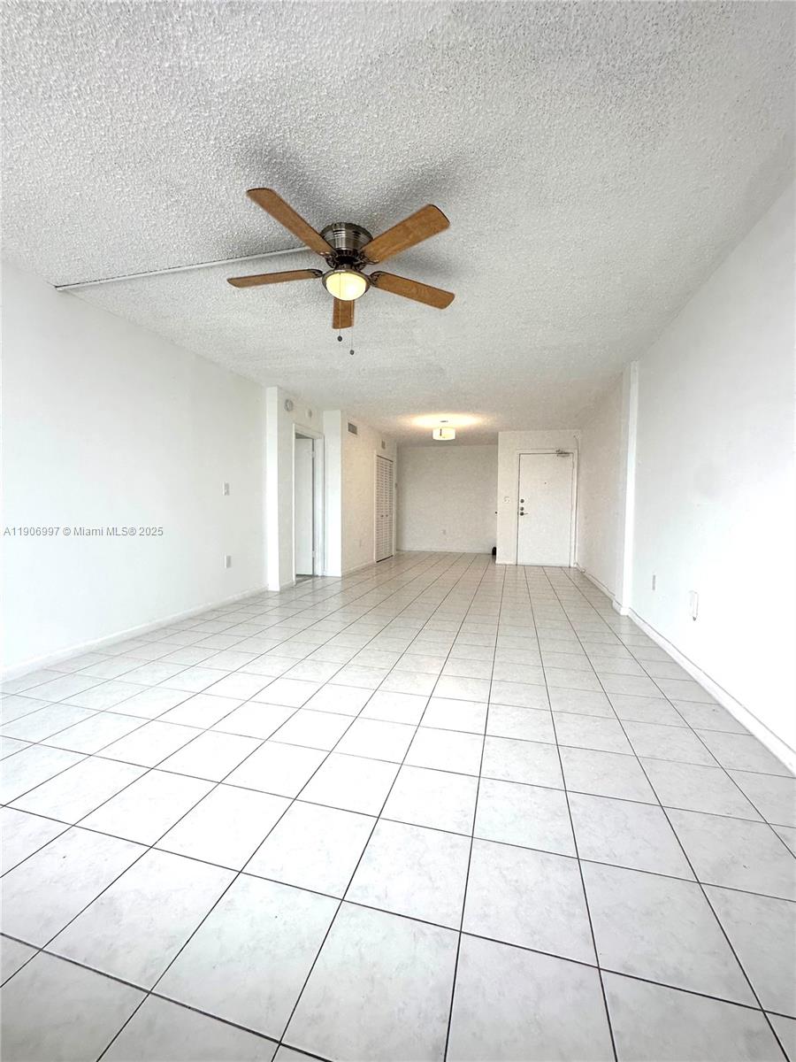 245 18th Street, Unit 801 Miami Beach, FL 33139 - Photo 3 of 11 a view of an empty room and a chandelier fan