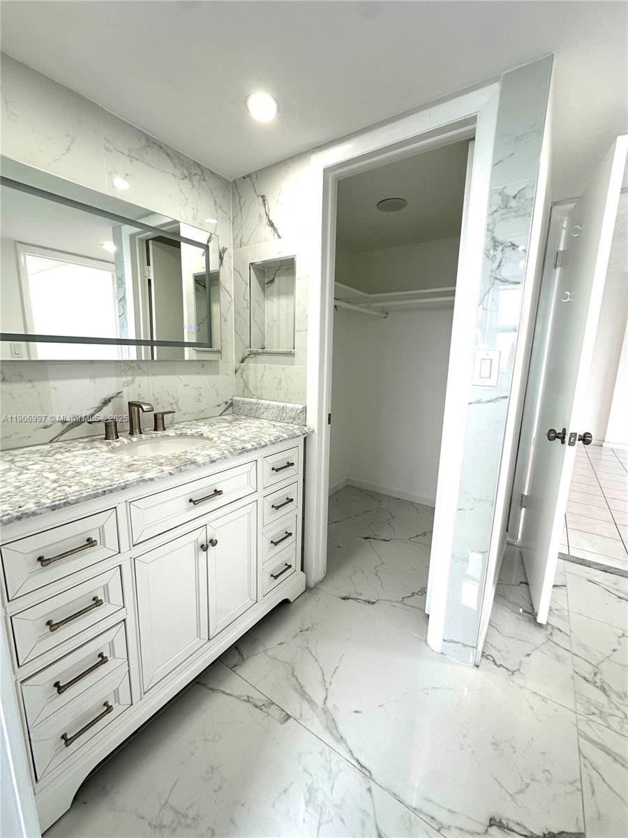 245 18th Street, Unit 801 Miami Beach, FL 33139 - Photo 6 of 11 a bathroom with a granite countertop sink mirror and