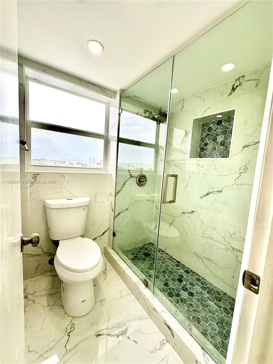 245 18th Street, Unit 801 Miami Beach, FL 33139 - Photo 8 of 11 a bathroom with a toilet and a shower