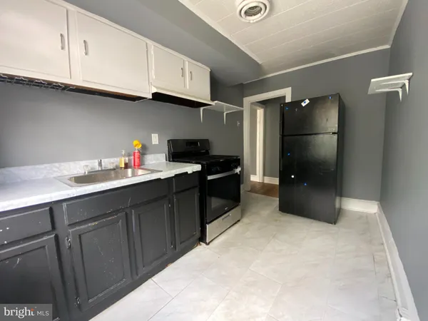 a kitchen with a sink and cabinets