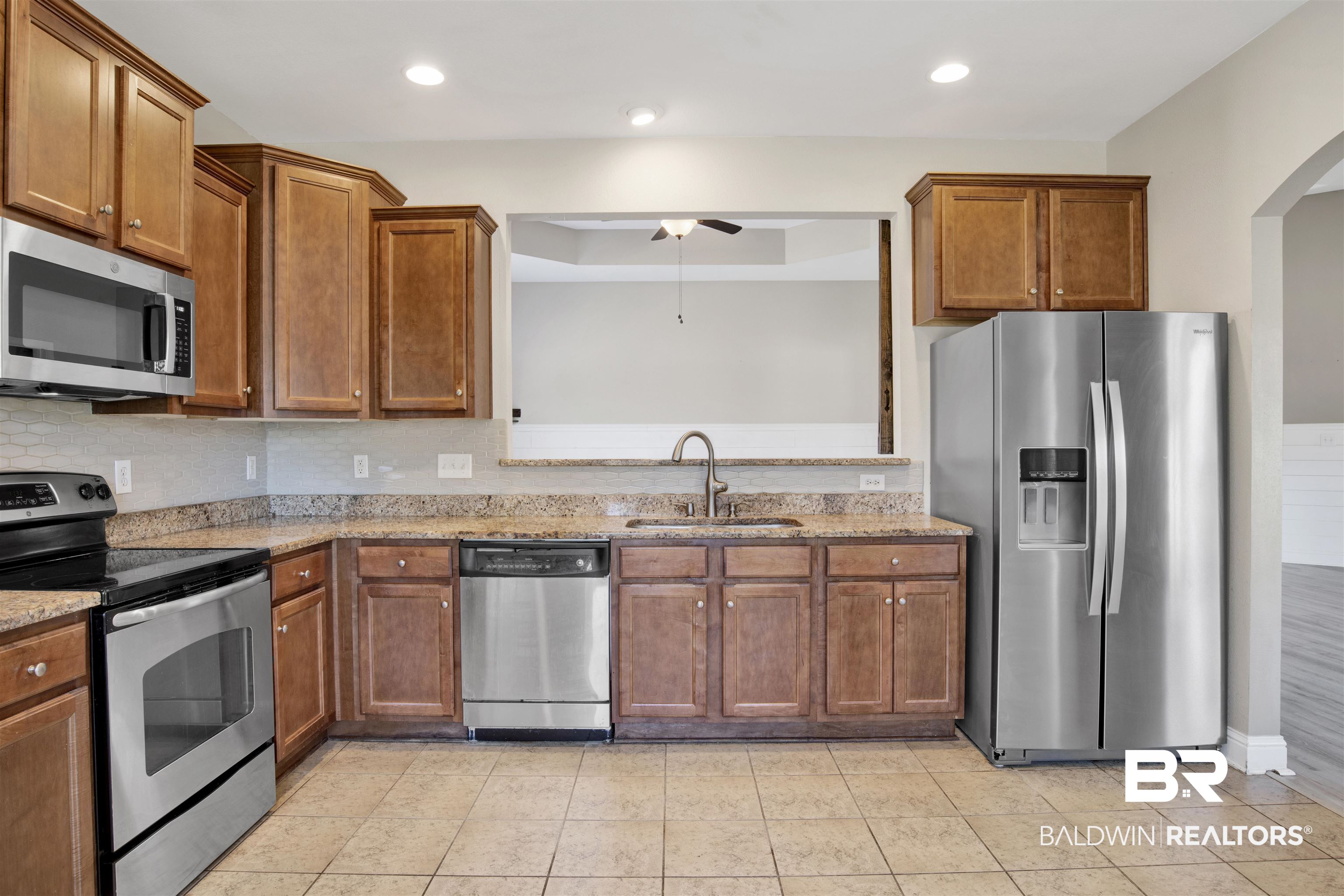 24159 Tullamore Drive Daphne, AL 36526 - Photo 15 of 31 Kitchen with ceiling fan, stainless steel appliances, light stone countertops, and sink