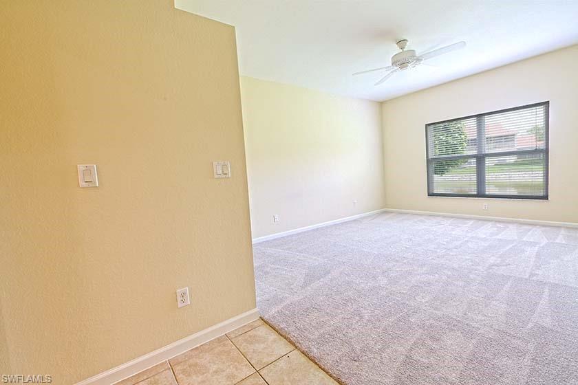 25064 Peacock Lane, Unit 102 Naples, FL 34114 - Photo 13 of 21 an empty room with windows
