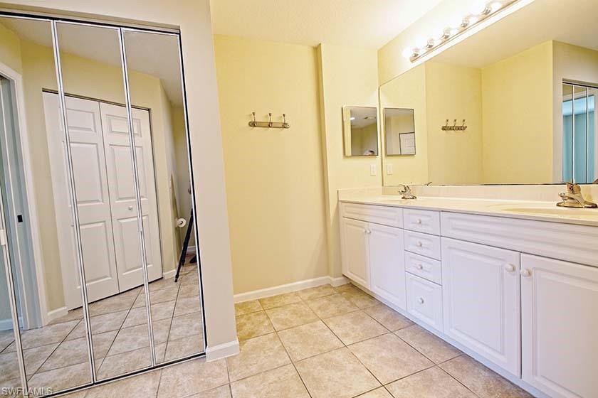 25064 Peacock Lane, Unit 102 Naples, FL 34114 - Photo 15 of 21 a spacious bathroom with a mirror sink and