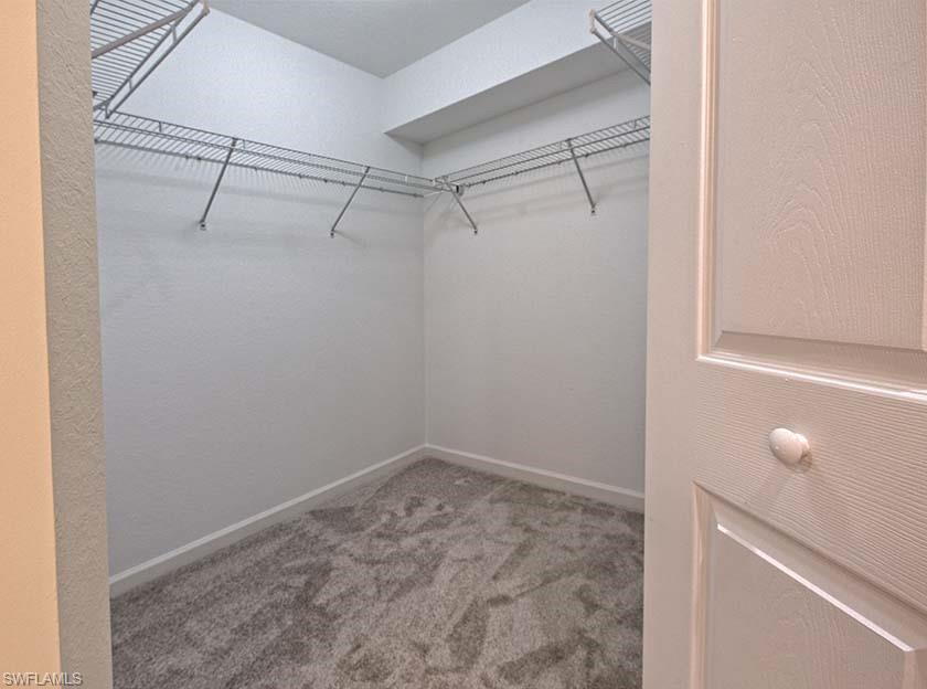 25064 Peacock Lane, Unit 102 Naples, FL 34114 - Photo 17 of 21 a view of a room with racks on the wall