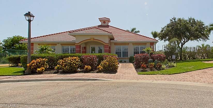 25064 Peacock Lane, Unit 102 Naples, FL 34114 - Photo 18 of 21 a front view of a house with a garden