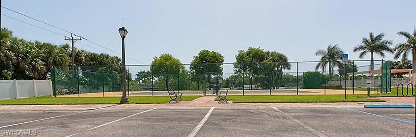 25064 Peacock Lane, Unit 102 Naples, FL 34114 - Photo 19 of 21 a view of a swimming pool with a yard