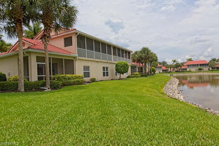 25064 Peacock Lane, Unit 102 Naples, FL 34114 - Photo 3 of 21 a front view of a house with garden