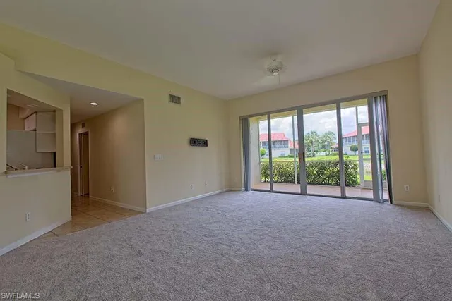 a view of an empty room with a sliding door