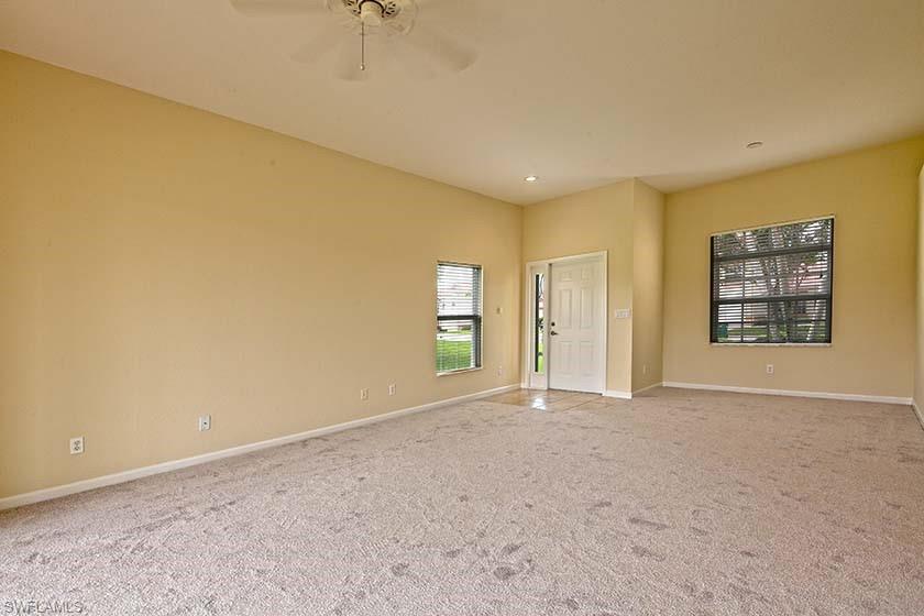 25064 Peacock Lane, Unit 102 Naples, FL 34114 - Photo 6 of 21 an empty room with windows