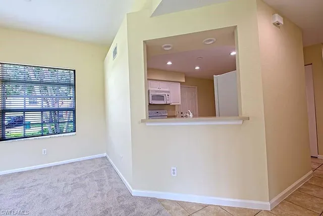 a view of a hallway with wooden floor and a large window