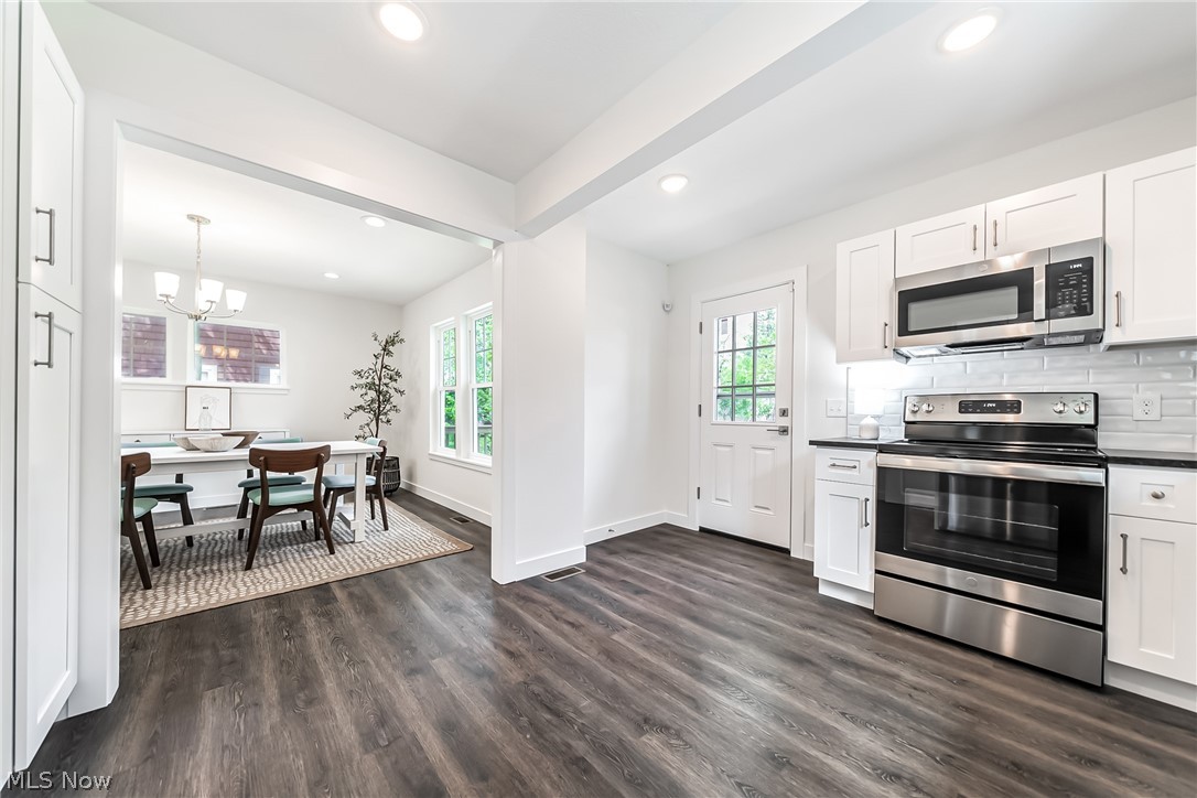 3959 Ardmore Road Cleveland Heights, OH 44121 - Photo 11 of 38 Kitchen with plenty of natural light, dark wood-type flooring, stainless steel appliances, and a notable chandelier