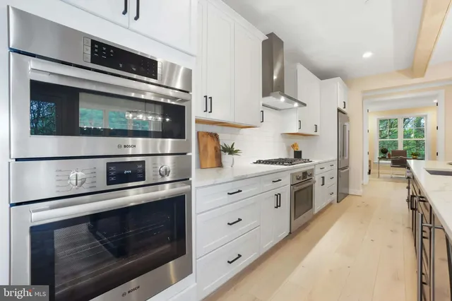 a kitchen with stainless steel appliances a stove microwave and cabinets