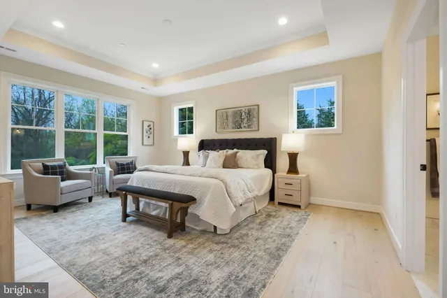 a bedroom with a bed and glass window