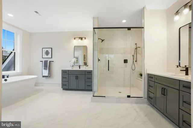 a bathroom with a tub sink shower and mirror
