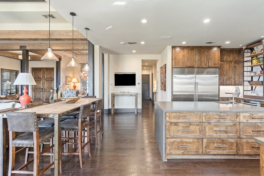 14423 Ridgetop Terrace Austin, TX 78732 - Photo 20 of 49 a open kitchen with stainless steel appliances kitchen island granite countertop a table and chairs in it