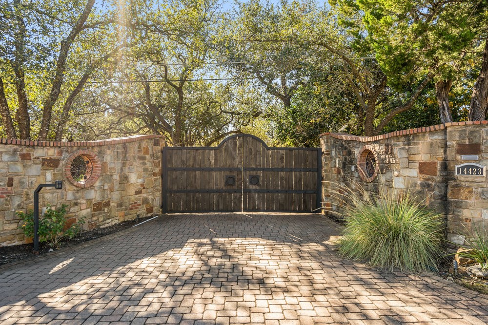 14423 Ridgetop Terrace Austin, TX 78732 - Photo 2 of 49 a view of a wooden fence next to a yard