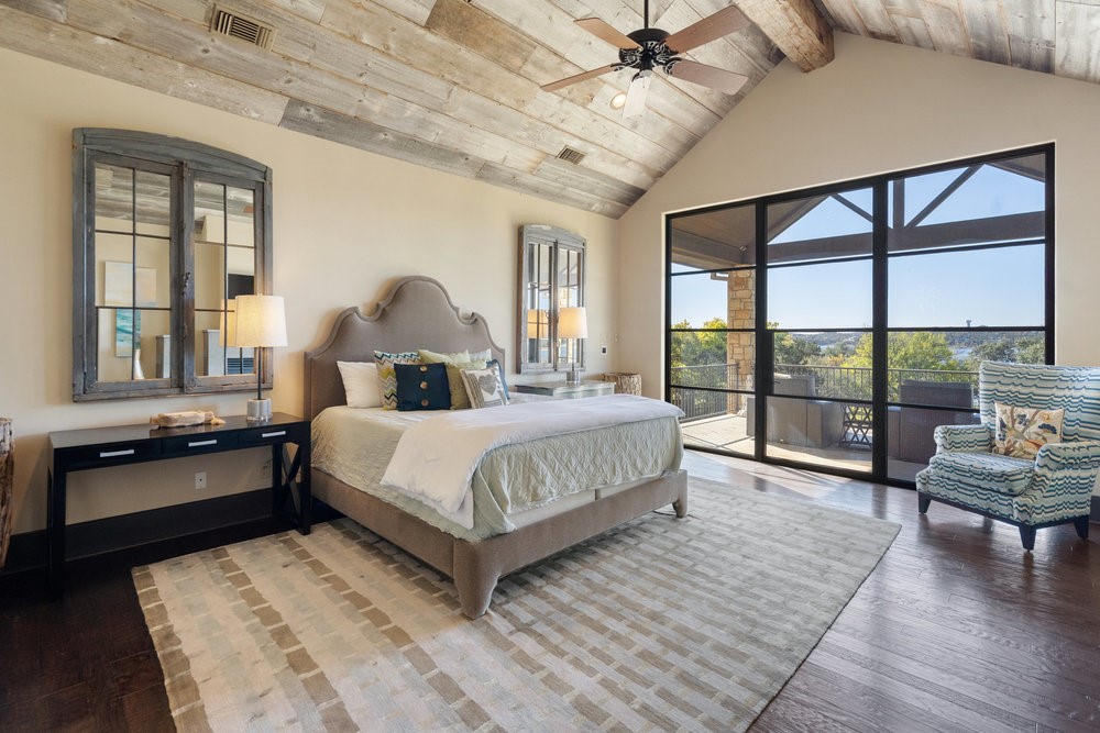 14423 Ridgetop Terrace Austin, TX 78732 - Photo 24 of 49 a bedroom with a bed and wooden floor