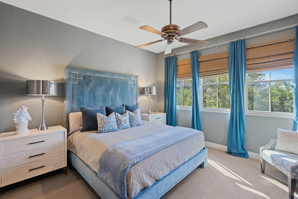 14423 Ridgetop Terrace Austin, TX 78732 - Photo 27 of 49 a bedroom with a bed and a chandelier