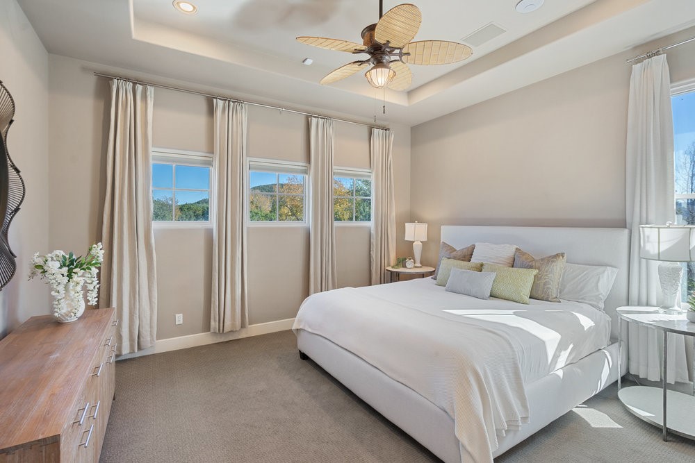 14423 Ridgetop Terrace Austin, TX 78732 - Photo 28 of 49 a bedroom with a large bed and a chandelier