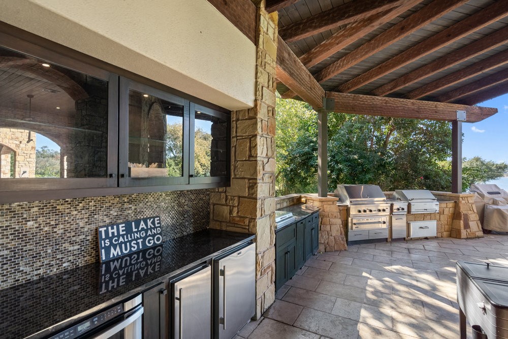 14423 Ridgetop Terrace Austin, TX 78732 - Photo 37 of 49 a open kitchen with granite countertop a sink and a counter top space