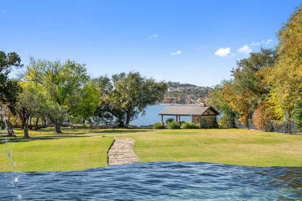 a view of swimming pool with outdoor seating and yard in back