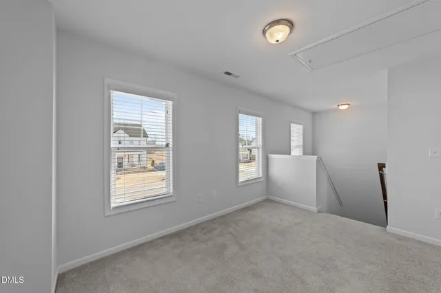 a view of empty room with window and fireplace